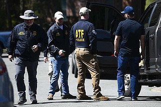 ATF agents wait outside as the Arkansas State Police Criminal Investigation Division investigates an officer-involved shooting that occurred March 19 in Little Rock. The ATF was serving a federal search warrant on the home of former Clinton National Airport executive director Bryan Malinowski, 53, who was fatally shot during the raid. (Arkansas Democrat-Gazette/Stephen Swofford)